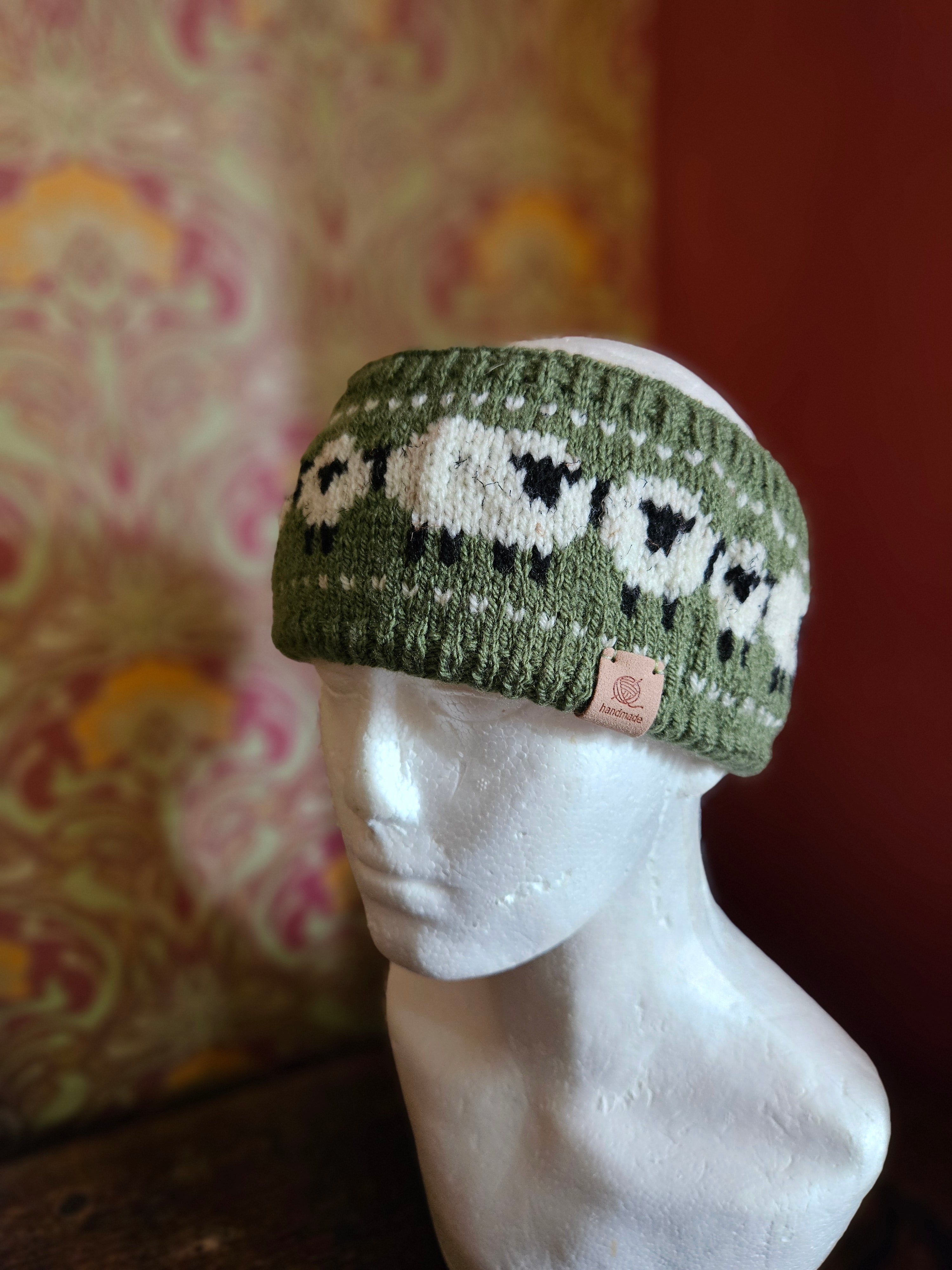 Earwarmer with sheep design in Olive. Fully lined.