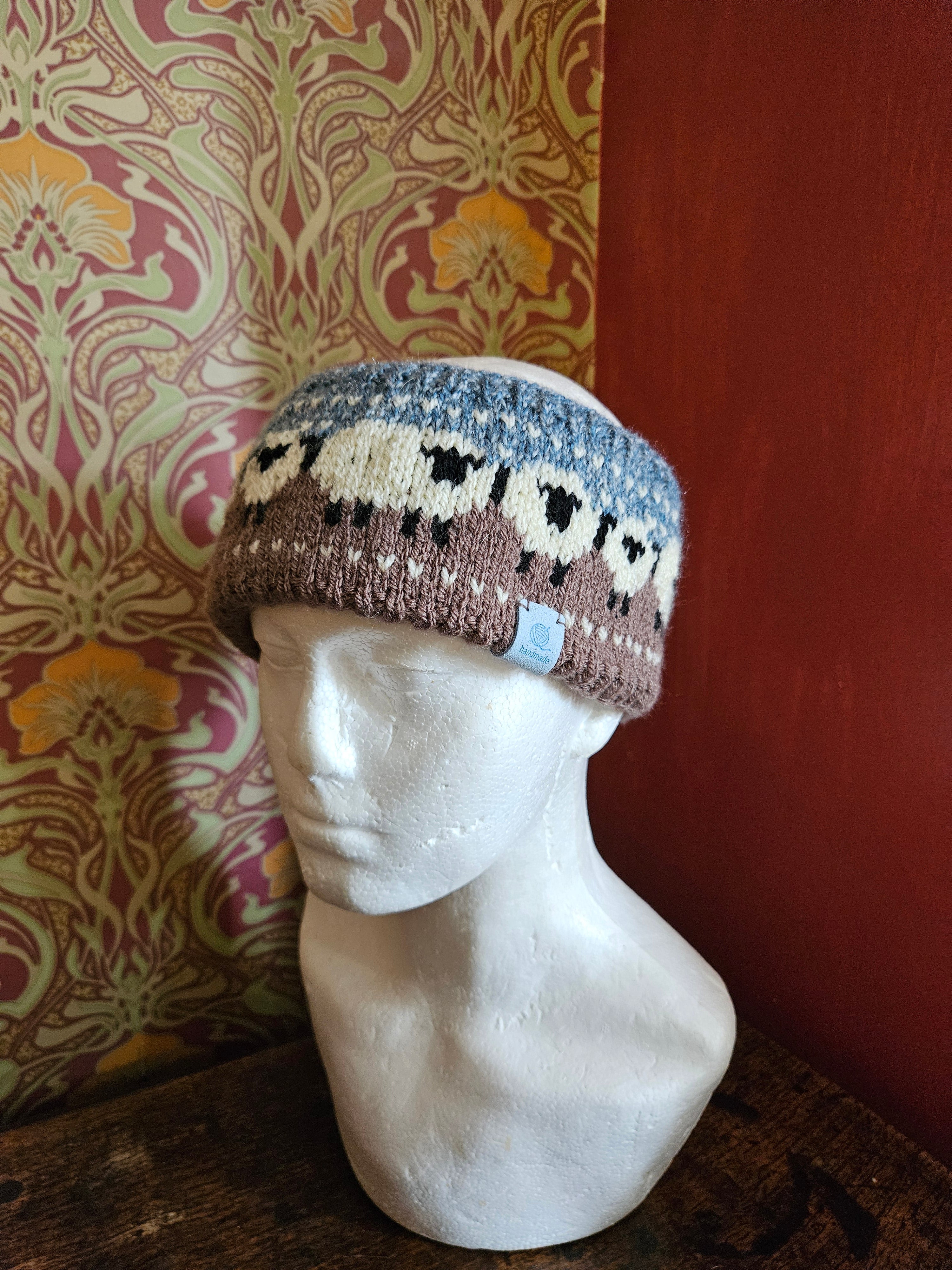 Earwarmer with sheep design. Fully lined