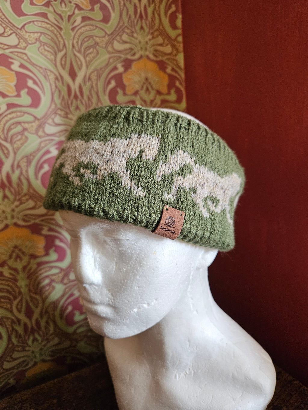 Earwarmer with horse design. Fully lined