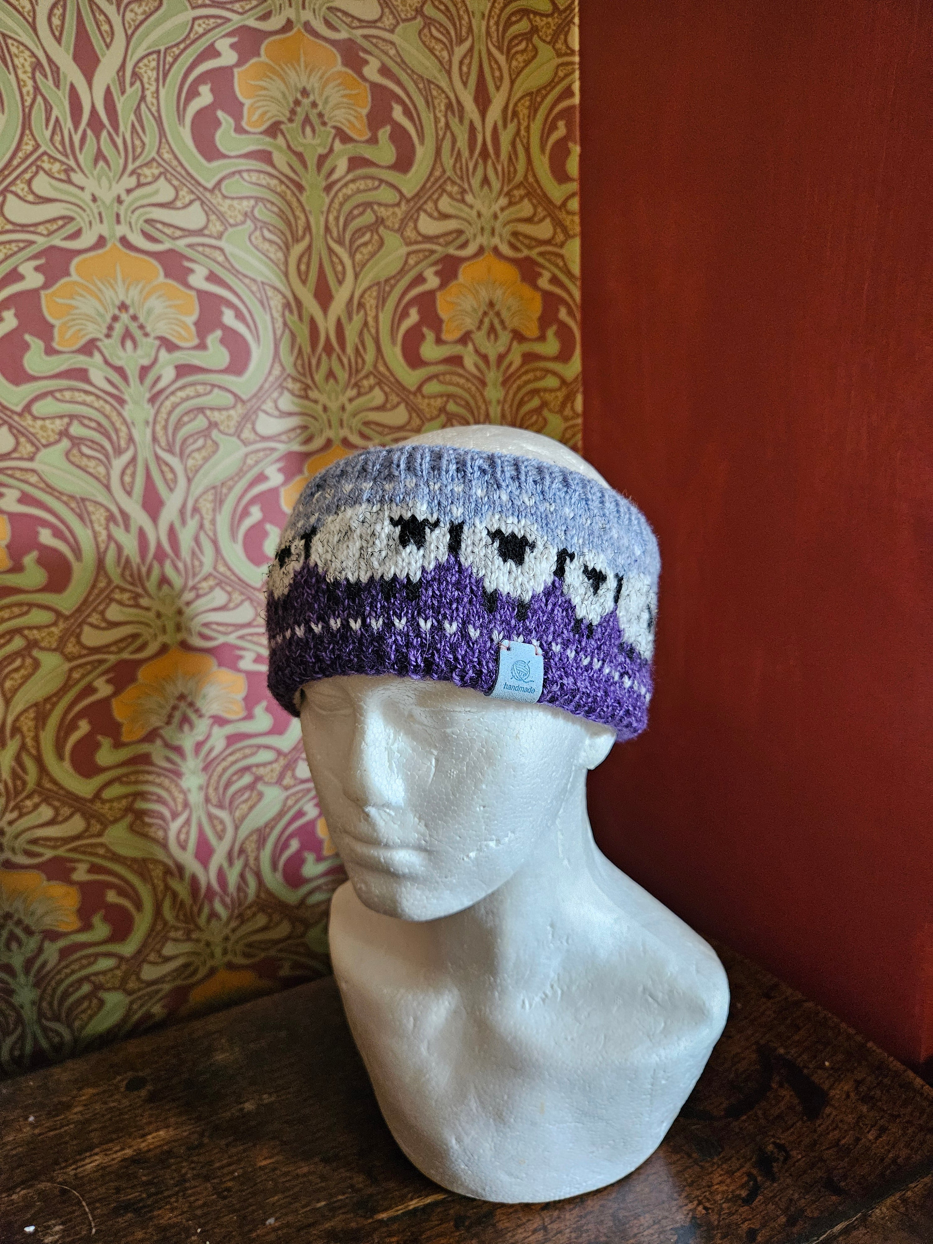 Sheep design earwarmer in plum and light blue
