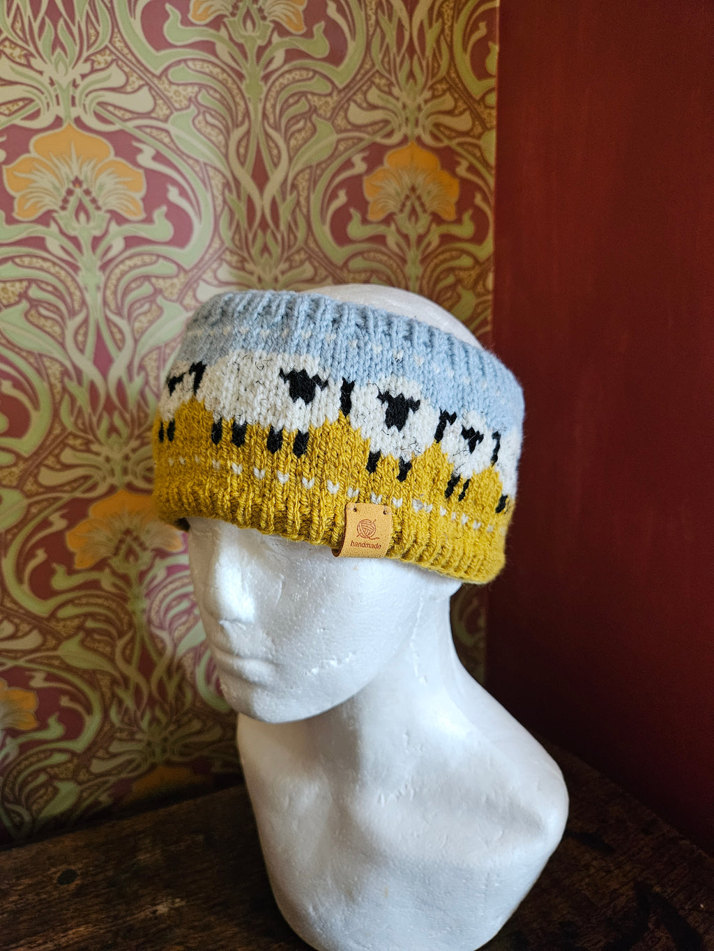 Earwarmer with sheep design. Fully lined