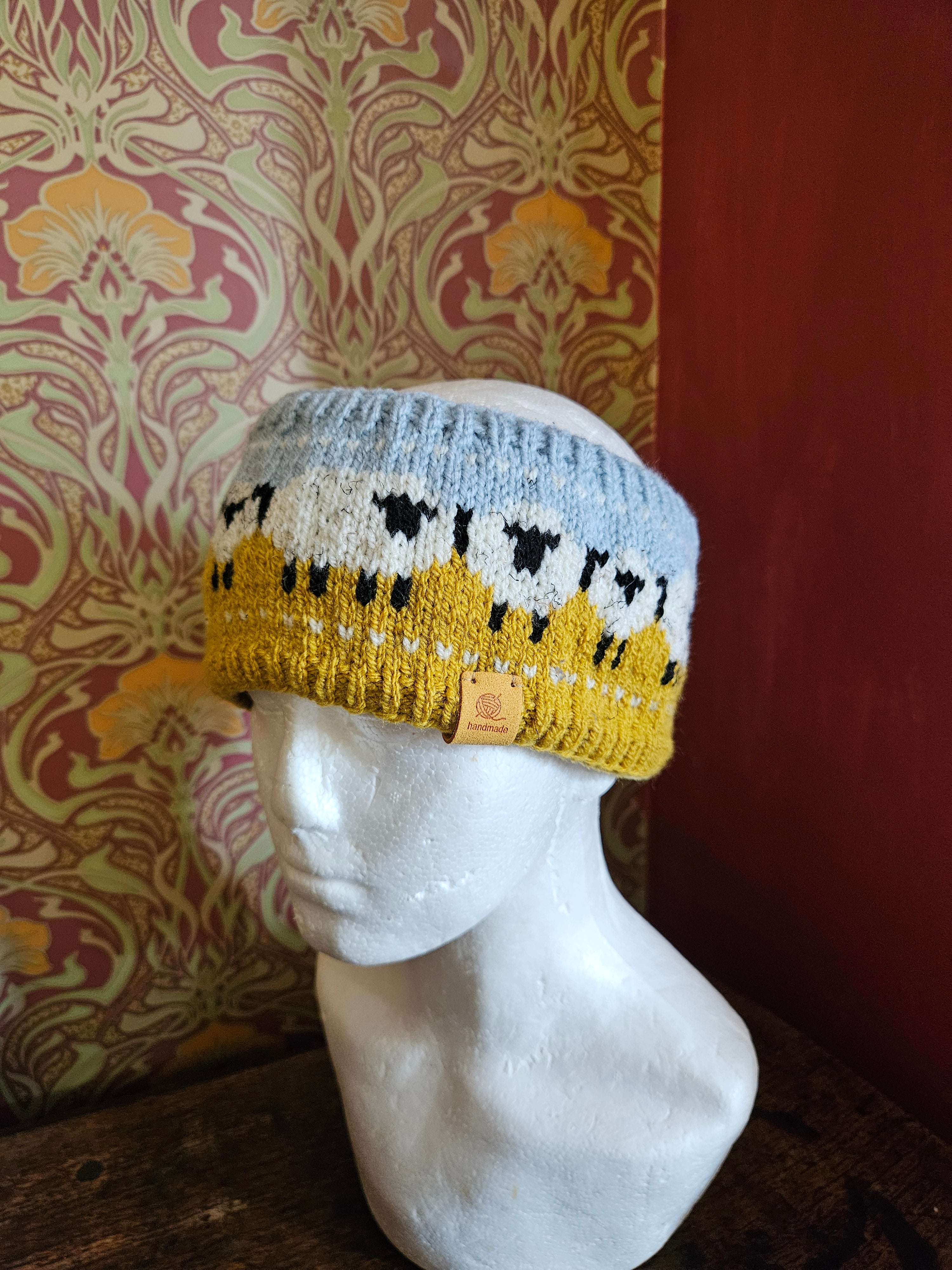 Earwarmer with sheep design. Fully lined