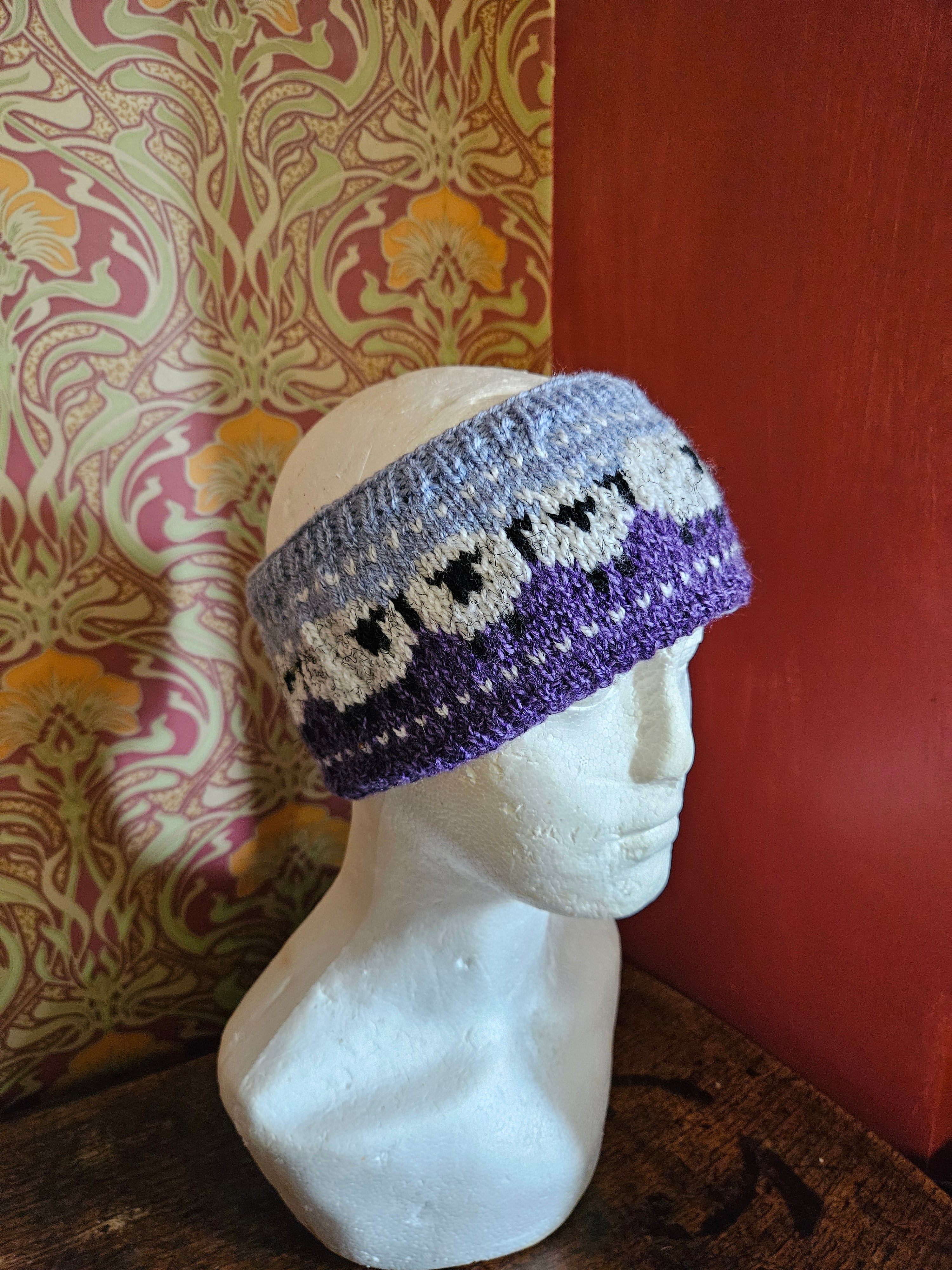 Sheep design earwarmer in plum and light blue