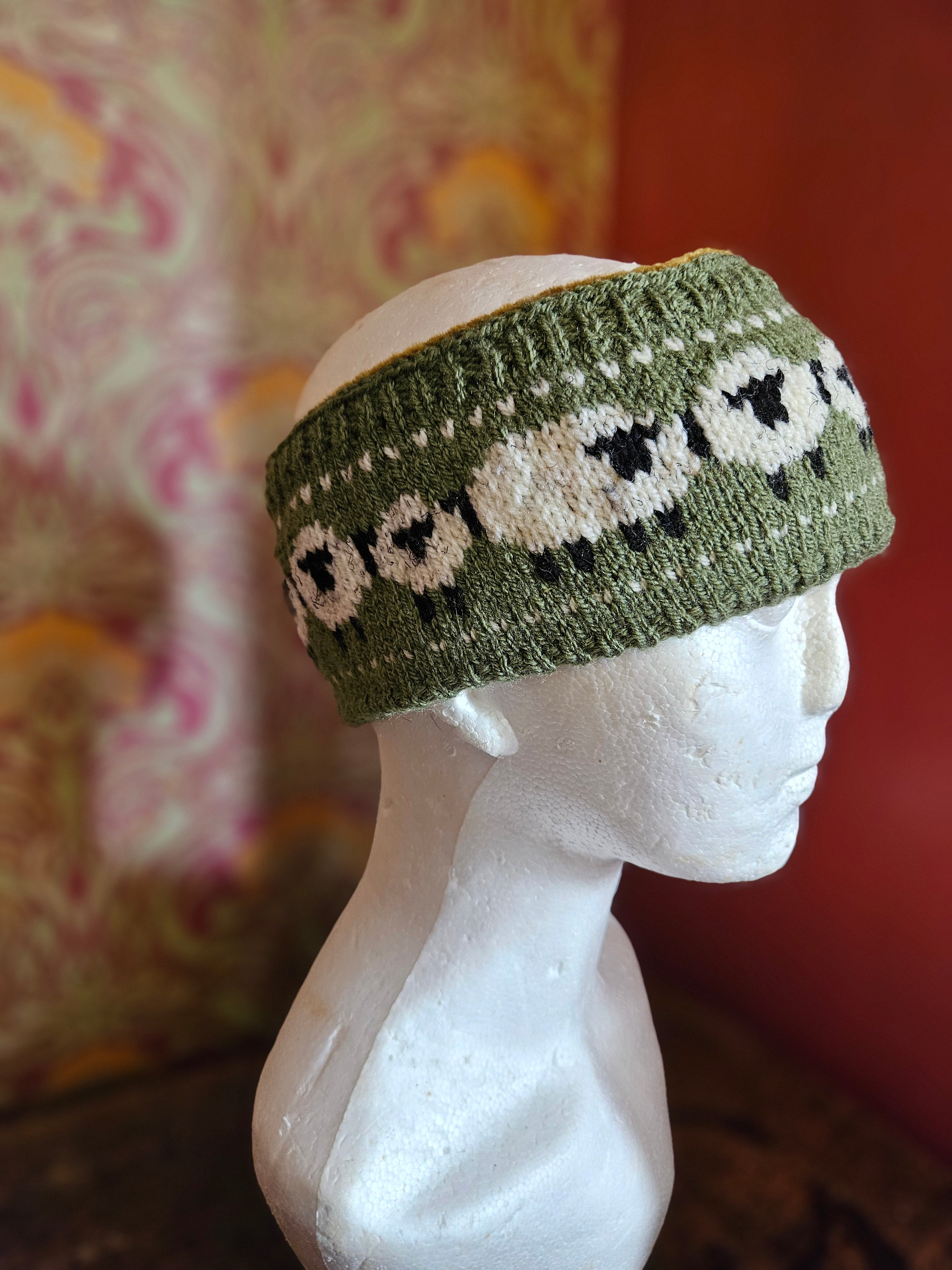 Earwarmer with sheep design in Olive. Fully lined.